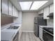 Efficient kitchen design with modern white cabinets, stainless steel appliances, and ample overhead lighting at 7790 W 87Th Drive Dr # D, Arvada, CO 80005