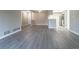 Open-concept living space with stylish gray floors, a kitchen view, and ample natural light from the skylight at 7790 W 87Th Drive Dr # D, Arvada, CO 80005