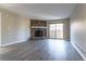 Spacious living room featuring modern floors, a cozy stone fireplace, and a sliding glass door to a private outdoor area at 7790 W 87Th Drive Dr # D, Arvada, CO 80005