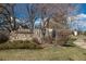 Neighborhood sign for Mountain Vista Village, set among mature trees at 7790 W 87Th Drive Dr # D, Arvada, CO 80005