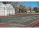 Community tennis court with net and fenced in perimeter at 7790 W 87Th Drive Dr # D, Arvada, CO 80005