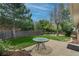 The backyard boasts a spacious patio, lush green lawn, mature trees, and space for entertaining at 9320 W 48Th Ave, Wheat Ridge, CO 80033