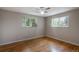Bedroom with hardwood floors, windows, and a ceiling fan at 9320 W 48Th Ave, Wheat Ridge, CO 80033
