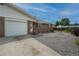 Charming single-story brick home featuring an attached garage and gravel front yard at 9320 W 48Th Ave, Wheat Ridge, CO 80033