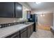 This kitchen features black cabinets, stainless steel refrigerator and a window with natural light at 9320 W 48Th Ave, Wheat Ridge, CO 80033