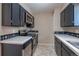Kitchen with black appliances and cabinets, white tile countertops, and neutral flooring at 9320 W 48Th Ave, Wheat Ridge, CO 80033