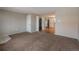 Spacious living room with carpet flooring and access to the kitchen and hallway at 9320 W 48Th Ave, Wheat Ridge, CO 80033