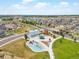 Aerial view of community park with playground, barn and silo, a splash pad, and green space at 5205 Periwinkle Way, Brighton, CO 80640