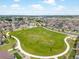 Aerial view showcases a large green space in the neighborhood at 5205 Periwinkle Way, Brighton, CO 80640