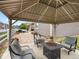 A cozy backyard featuring a gazebo, seating, and barbecue area at 5205 Periwinkle Way, Brighton, CO 80640