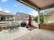 Covered patio boasts an outdoor kitchen with a grill, plus flower beds for entertaining at 5205 Periwinkle Way, Brighton, CO 80640