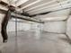 Unfinished basement space with concrete floor, exposed beams, and utilities at 5205 Periwinkle Way, Brighton, CO 80640