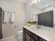 Well-maintained bathroom includes a vanity with sink, a toilet, and a shower/tub combination with shower curtain at 5205 Periwinkle Way, Brighton, CO 80640