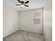 Neutral bedroom features a ceiling fan and window for natural light, plus neutral paint at 5205 Periwinkle Way, Brighton, CO 80640