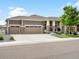 Charming exterior features a three-car garage and covered front porch for curb appeal at 5205 Periwinkle Way, Brighton, CO 80640