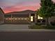 Charming home with a three-car garage, stone accents, a covered porch, and low-maintenance landscaping at 5205 Periwinkle Way, Brighton, CO 80640