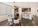 Eat-in kitchen with dark cabinets, white countertops, pendant lighting, and modern appliances at 5205 Periwinkle Way, Brighton, CO 80640