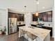 A spacious kitchen boasts granite counters, dark cabinets, and stainless steel appliances at 5205 Periwinkle Way, Brighton, CO 80640