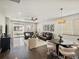 Spacious living room boasts hardwood floors, modern furnishings, and a sliding glass door to a private patio at 5205 Periwinkle Way, Brighton, CO 80640