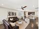 Spacious living room flowing into the kitchen with hardwood floors and modern decor at 5205 Periwinkle Way, Brighton, CO 80640