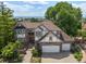 Expansive aerial view of home featuring a large yard, brick exterior, and three-car garage at 9117 Buck Hill Dr, Highlands Ranch, CO 80126