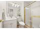 Bathroom with white cabinets, a sink, gold hardware, and a glass-enclosed shower at 9117 Buck Hill Dr, Highlands Ranch, CO 80126