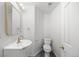 Powder room featuring a pedestal sink with gold fixtures and a classic white toilet at 9117 Buck Hill Dr, Highlands Ranch, CO 80126