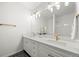 Double vanity bathroom with ample lighting, white cabinets, and gold fixtures at 9117 Buck Hill Dr, Highlands Ranch, CO 80126