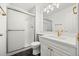 Bright bathroom featuring a shower with glass doors, white cabinets, and brushed gold hardware at 9117 Buck Hill Dr, Highlands Ranch, CO 80126