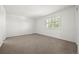 Carpeted bedroom with a bright window allowing for natural light at 9117 Buck Hill Dr, Highlands Ranch, CO 80126