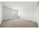 Minimalist carpeted bedroom with bright window providing natural light at 9117 Buck Hill Dr, Highlands Ranch, CO 80126