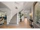 Grand foyer with a curved staircase, hardwood floors, and elegant decor at 9117 Buck Hill Dr, Highlands Ranch, CO 80126