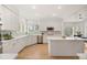 Modern kitchen with white cabinets, stainless steel appliances, marble backsplash, and a center island at 9117 Buck Hill Dr, Highlands Ranch, CO 80126