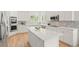 Bright, spacious kitchen with white cabinets, stainless steel appliances, and a large center island at 9117 Buck Hill Dr, Highlands Ranch, CO 80126