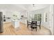 Open kitchen and dining area with hardwood floors, white cabinets, and stainless appliances at 9117 Buck Hill Dr, Highlands Ranch, CO 80126