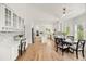 Bright kitchen and dining area with hardwood floors, white cabinets, and stainless steel appliances at 9117 Buck Hill Dr, Highlands Ranch, CO 80126