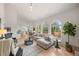Open-concept living room with large windows and hardwood floors, perfect for entertaining at 9117 Buck Hill Dr, Highlands Ranch, CO 80126