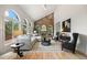 Spacious living room with brick fireplace, vaulted ceilings, and ample natural light at 9117 Buck Hill Dr, Highlands Ranch, CO 80126