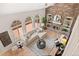 Inviting living room with a brick fireplace, built-in bookshelves, and large windows at 9117 Buck Hill Dr, Highlands Ranch, CO 80126