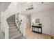 Elegant staircase with white railings and light hardwood floors at 9117 Buck Hill Dr, Highlands Ranch, CO 80126