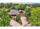 Aerial view of a charming home with mature trees, landscaped grounds, and a spacious driveway at 5420 Crestone Cir, Boulder, CO 80301