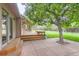 Private backyard with a mature shade tree, wooden deck, and patio area perfect for outdoor living at 5420 Crestone Cir, Boulder, CO 80301