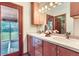 Bathroom with double vanity and door that leads to the backyard patio at 5420 Crestone Cir, Boulder, CO 80301
