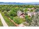 Charming home featuring a well-manicured lawn, mature trees, and a wooden fence at 5420 Crestone Cir, Boulder, CO 80301
