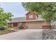 Charming home featuring a two-car garage, wood siding, and an inviting landscaped front yard at 5420 Crestone Cir, Boulder, CO 80301
