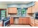 Bright kitchen featuring stainless steel appliances, tile backsplash, and large window at 5420 Crestone Cir, Boulder, CO 80301