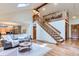 Spacious living room features stairs to a loft, hardwood floors and lots of natural light at 5420 Crestone Cir, Boulder, CO 80301