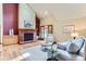 Bright living room features a brick fireplace, vaulted ceilings, and hardwood floors at 5420 Crestone Cir, Boulder, CO 80301