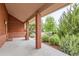 Inviting front porch with brick columns, wood siding and views of the lush landscaping at 5420 Crestone Cir, Boulder, CO 80301