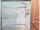 Bathroom shower with a shower head and patterned sliding glass door at 5420 Crestone Cir, Boulder, CO 80301